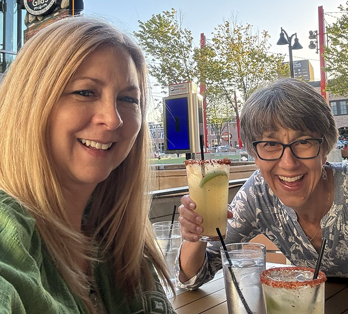 Pam and Diana holding drinks