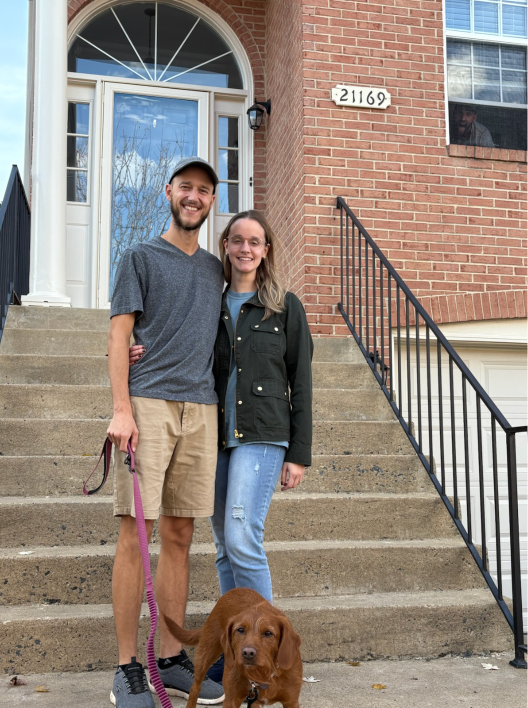Ben and Sophie standing in front of a brick towmhouse